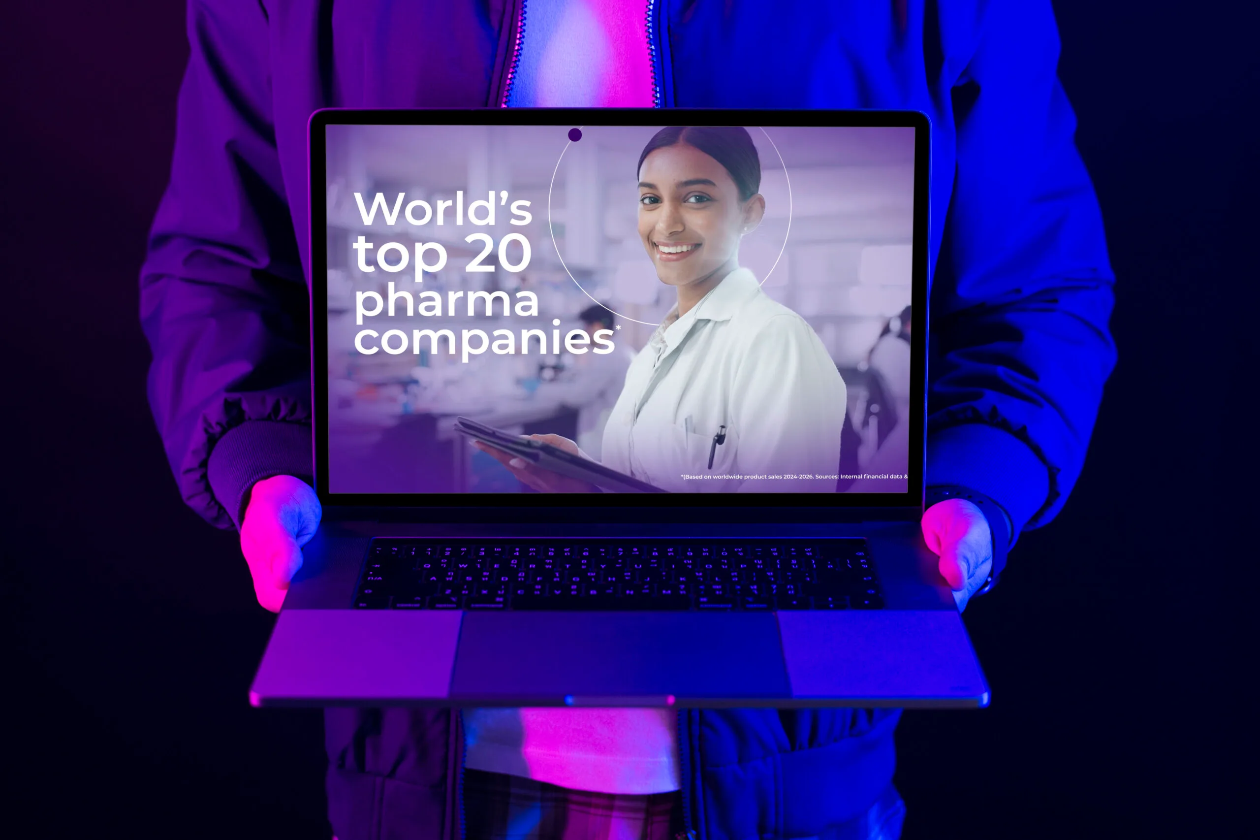 Man showing laptop screen with a video created for Global Pharmaceutical company Inizio A creative image of a man holding a laptop displaying a freeze frame of a video animated for Global Pharmaceutical company Inizio by Emotive Eye - Fractional Content Production
