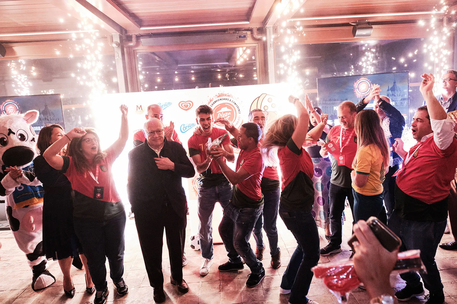 A celebration photograph during the Pizza Hut Europe Awards 2024 in Madrid A photograph captured by Fractional Content Producer Emotive Eye during the Pizza Hut 2024 European Championships + Conference in Madrid as team Portugal won the top award!