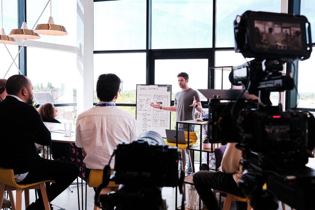 Stuart James directing the recording of a B2B marketing presentation with two cameras and lighting and audio